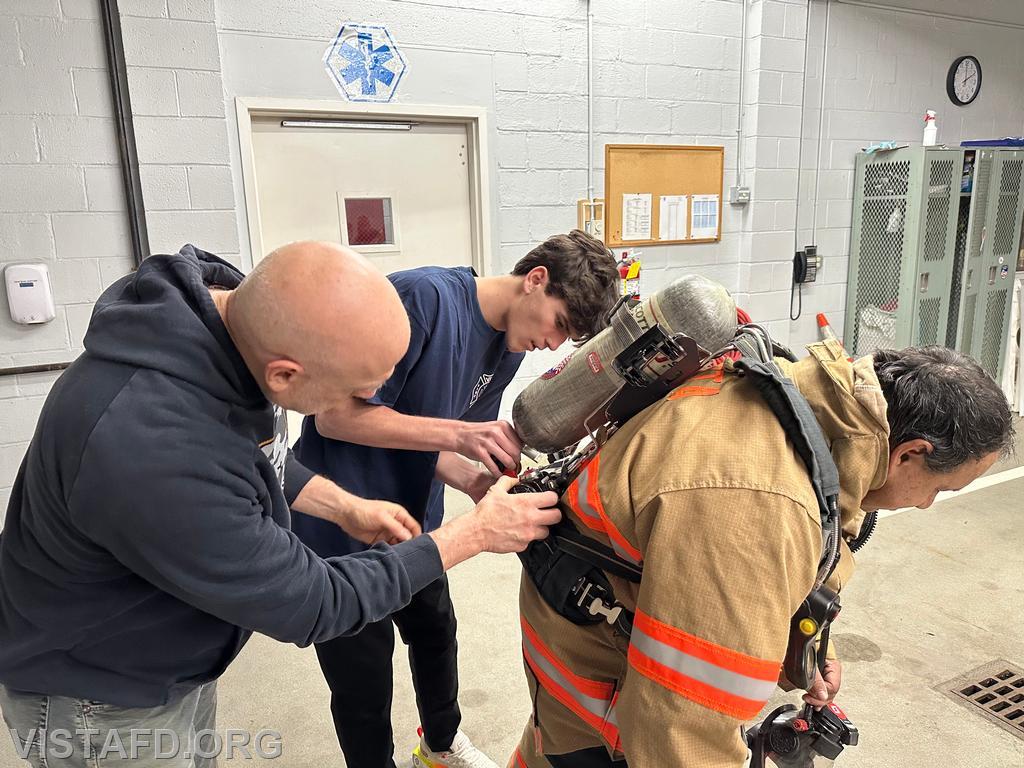 Firefighter Dan Hochman and Probationary Firefighter/EMT Candidate Ashtin Rama going over how to change an SCBA on Firefighter Martin Rojas – 04/14/25