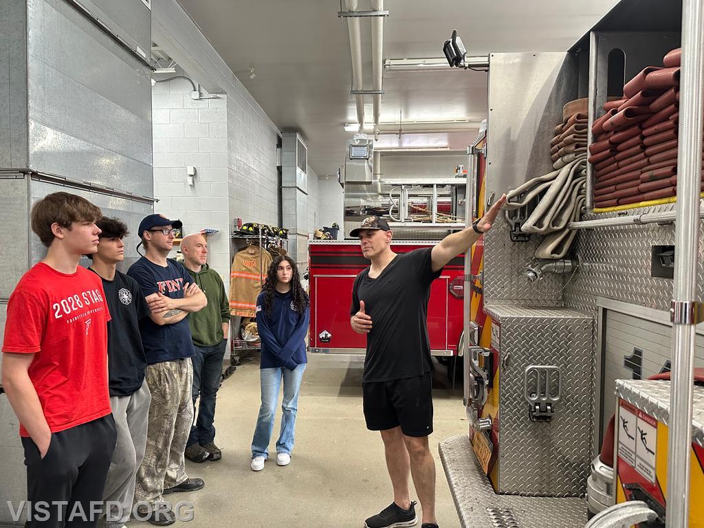 Captain Marc Baiocco demonstrating the supply line hose setup on Engine 141 during &quot;Module 4 – Fire Scene Operations&quot; – 05/04/25