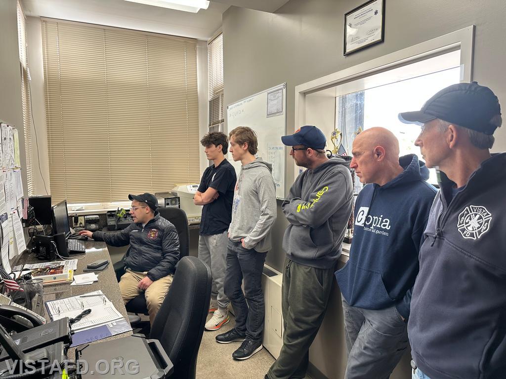 Firefighter Adam Ferman explains the radio room computer during Module 2: &quot;Learning the Radio Room - 04/13/25