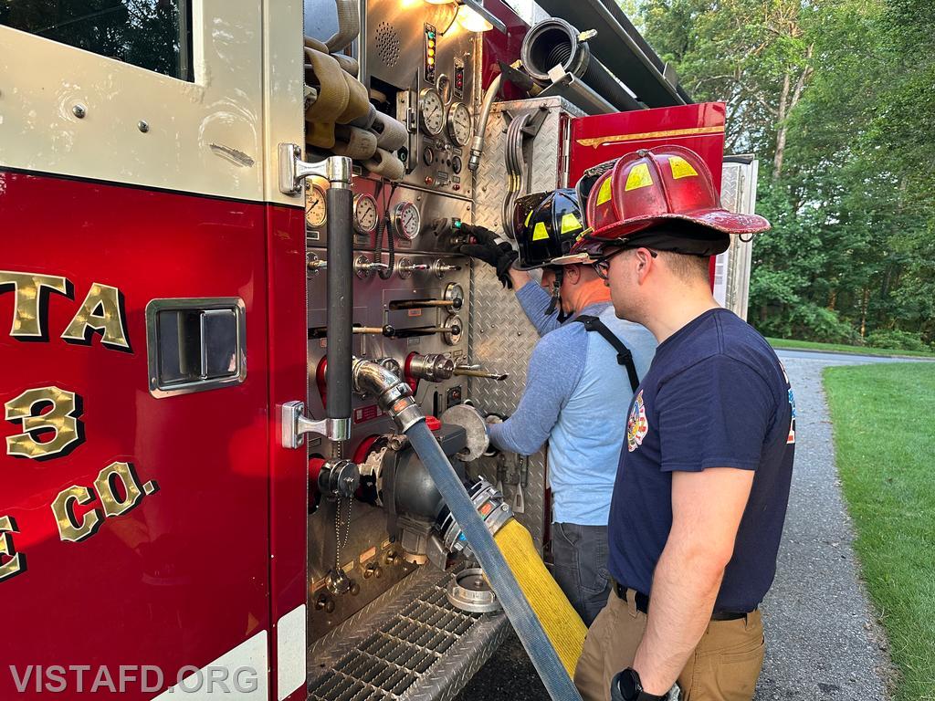 Firefighter Dan Hochman operating the Engine 143 pump panel as Station Manager Brian Porco looks on - 06/23/25