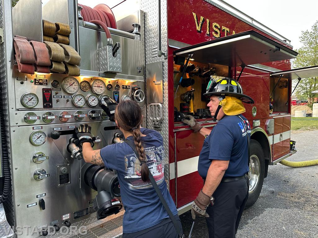 Foreman Kyla Whalen operating the Engine 142 pump panel as Foreman Brian Sferra looks on - 06/23/25