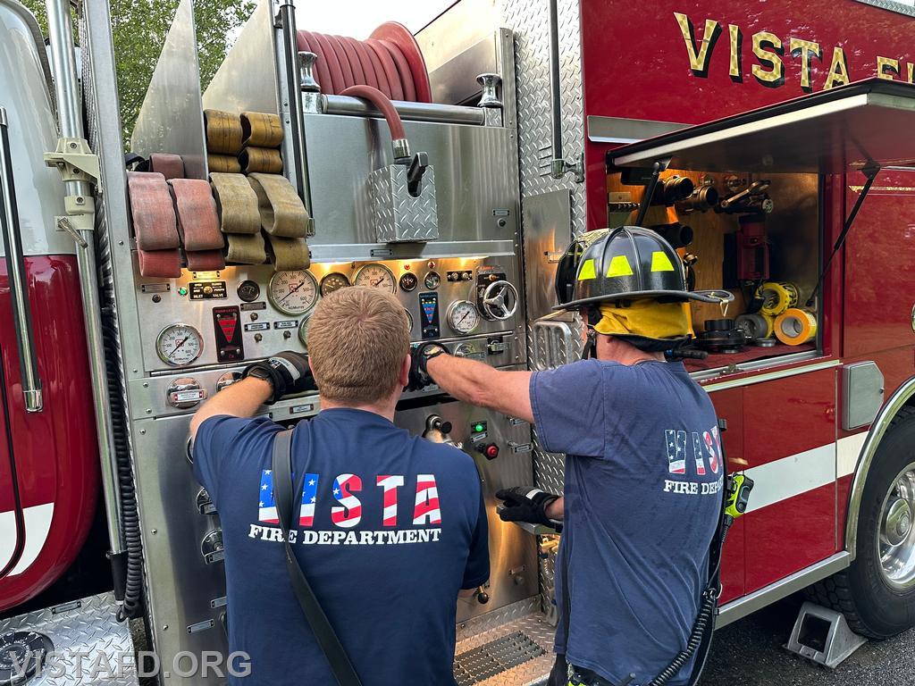 Firefighter Phil Wanderman operating the Engine 142 pump panel as Lead Foreman Mike Peck looks on - 06/23/25