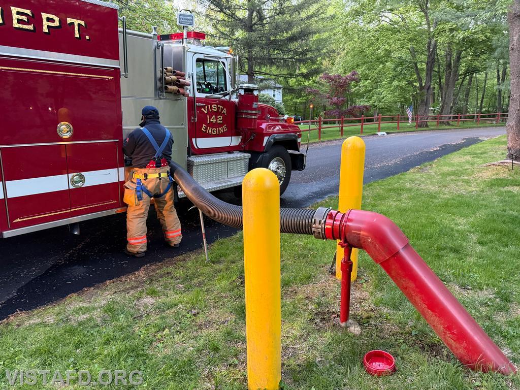 Foreman Martin Rojas connecting Engine 142 to the Robin Court dry hydrant - 05/11/26