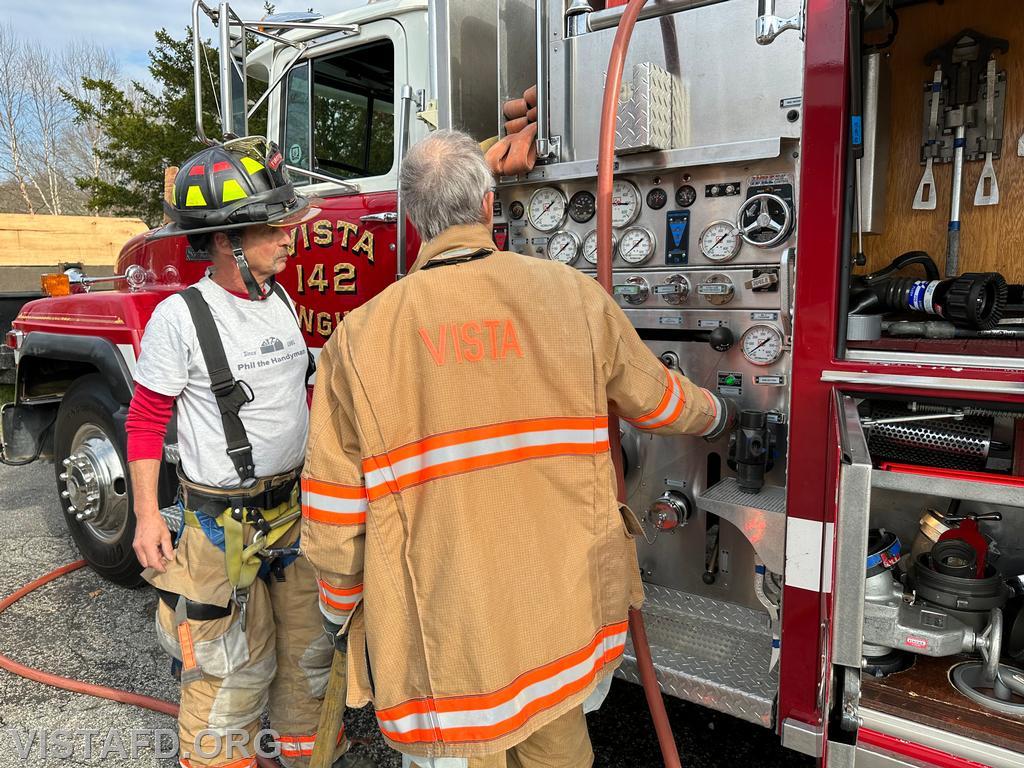 Probationary FF/EMT Candidate Andy Korman practices pumping Engine 142 as Firefighter Phil Katz looks on - 11/05/23
