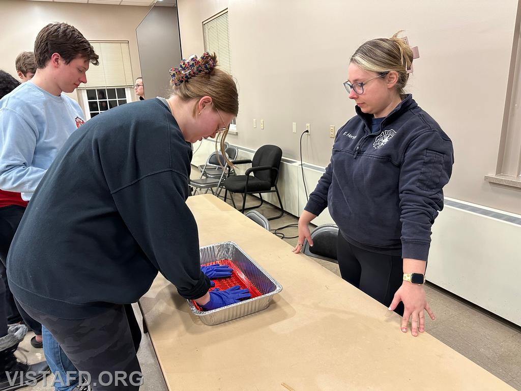 Foreman Isabel Fry practices taking off her &quot;blood soaked&quot; medical gloves as Lead Foreman Elly Hersam looks on - 01/29/24
