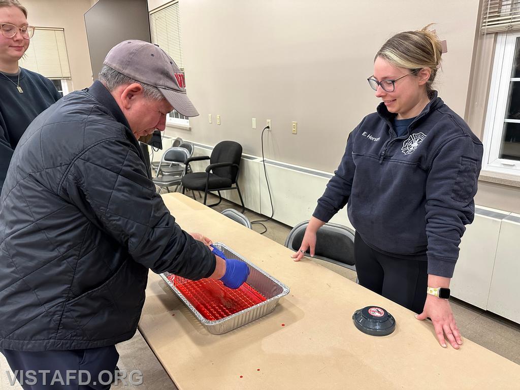Foreman Brian Sferra practices taking off his &quot;blood soaked&quot; medical gloves as Lead Foreman Elly Hersam looks on - 01/29/24