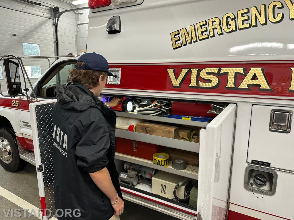 Probationary Firefighter Ty Graygor going over the equipment on Ambulance 84B2 during driver training - 08/18/24
