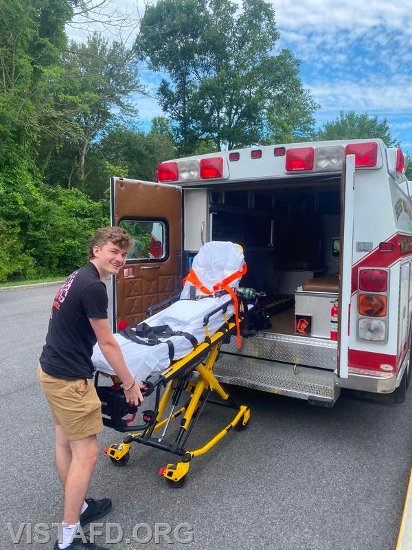 Probationary Firefighter Ty Graygor going over how to operate the stretcher during driver training - 07/07/24