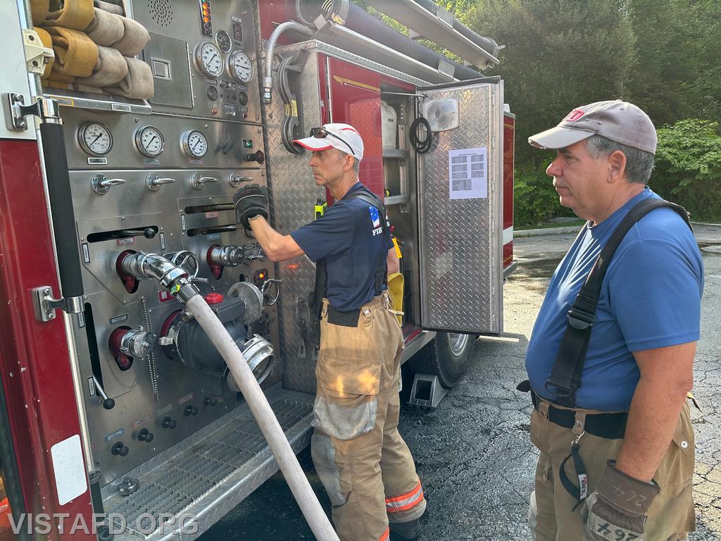 FF/EMT Andy Korman practicing how to use the Engine 143 pump panel as Foreman Brian Sferra looks on - 07/21/24