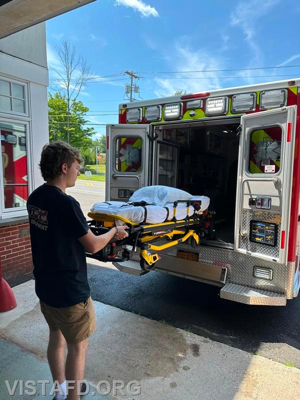 Probationary Firefighter Ty Graygor going over how to operate the stretcher during driver training - 07/21/24
