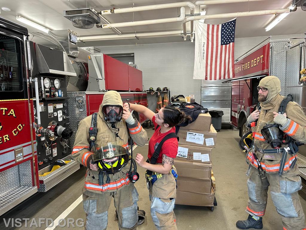 Foreman Kyla Whalen demonstrating how to properly wear an SCBA to Firefighter Dan Hochman - 01/12/25