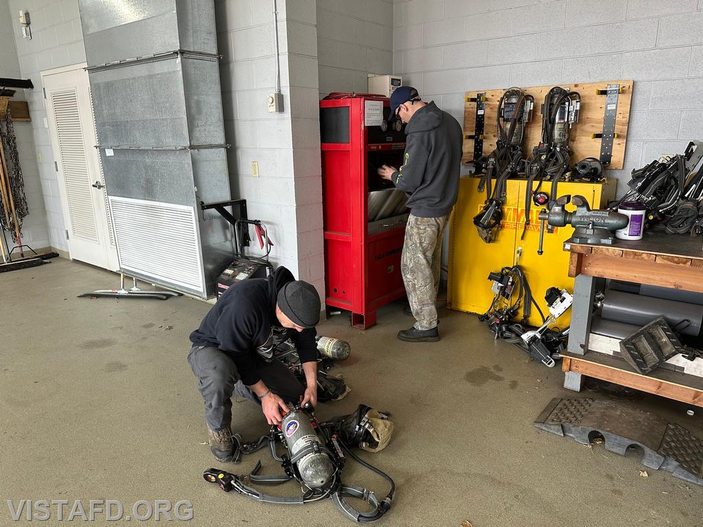 Firefighter Dan Hochman and Probationary Firefighter David Fignar reviewing the process for refilling SCBA bottles - 01/19/25