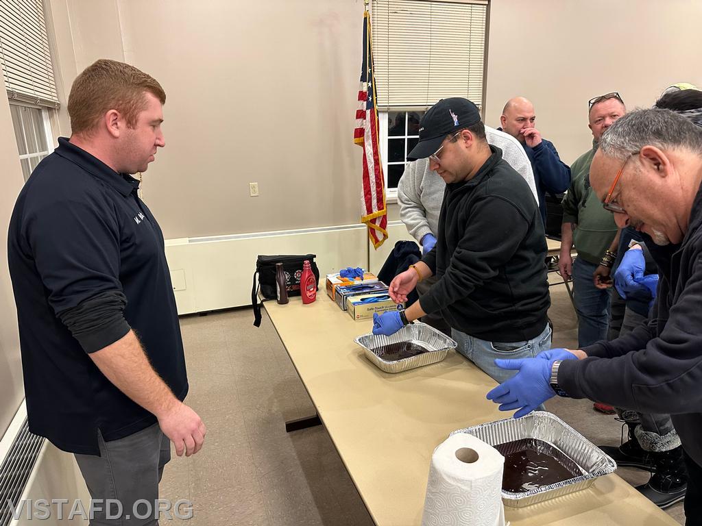 Firefighters Adam Ferman and Mark Albert practice removing their &quot;blood-soaked&quot; medical gloves while Lead Foreman Mike Peck looks on - 01/20/25