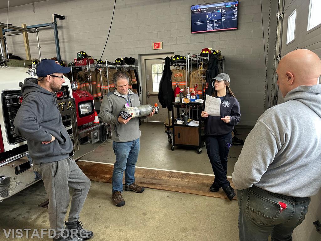 Foreman Kyla Whalen discussing the SCBA cylinder with Vista Fire Department personnel during the &quot;Firefighter Skills Class&quot; - 02/16/25