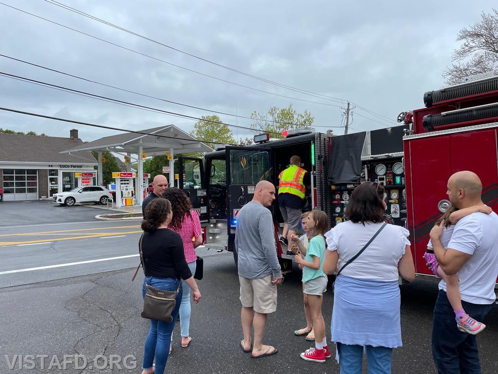 Members of the community getting firetruck rides on Engine 141 during the "Spaghetti Night and Open House" event
