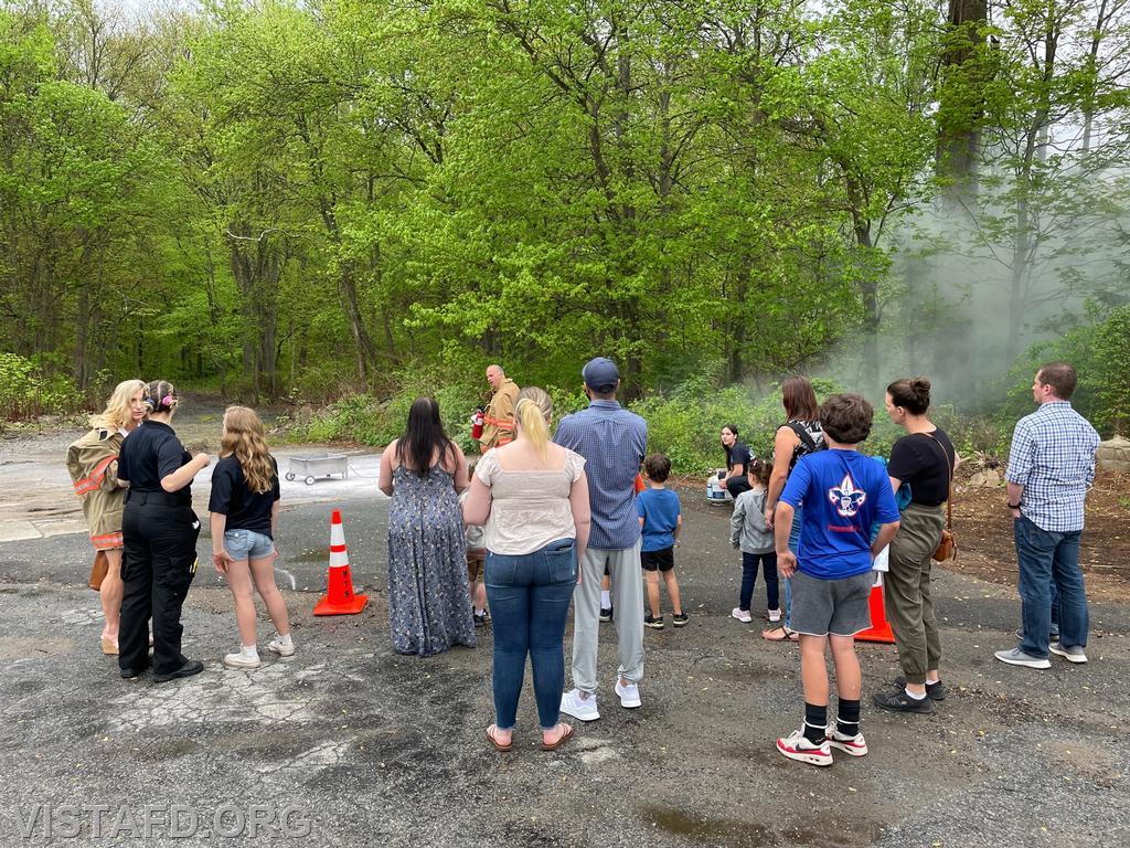 Members of the community learning how to use a fire extinguisher during the "Spaghetti Night and Open House" event