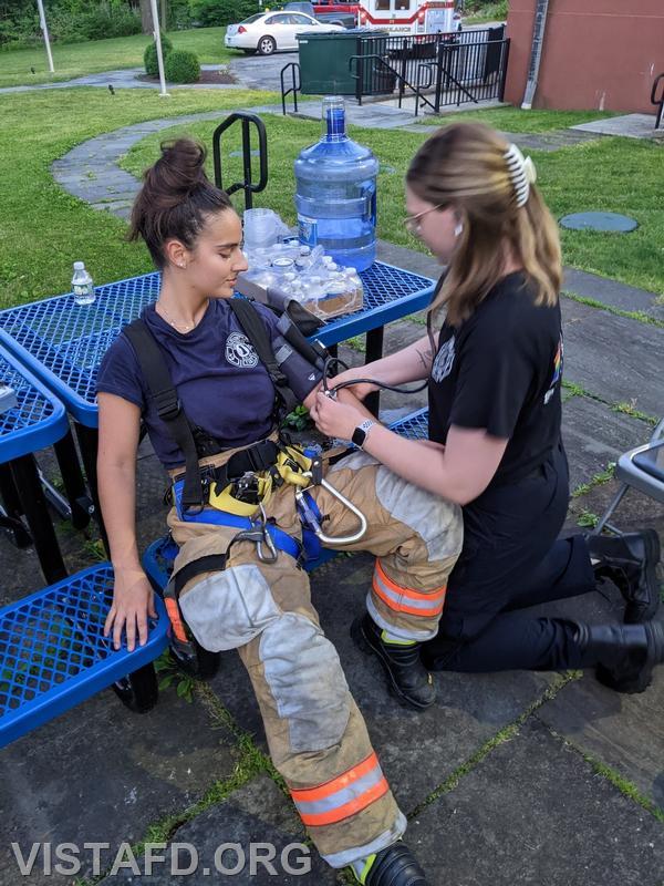 Foreman Isabel Fry conducting "rehab operations" on Firefighter Kyla Whalen