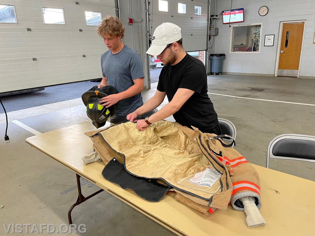 Probationary EMT Candidate Ian Ferman and Firefighter Adam Ferman conducting a gear inspection
