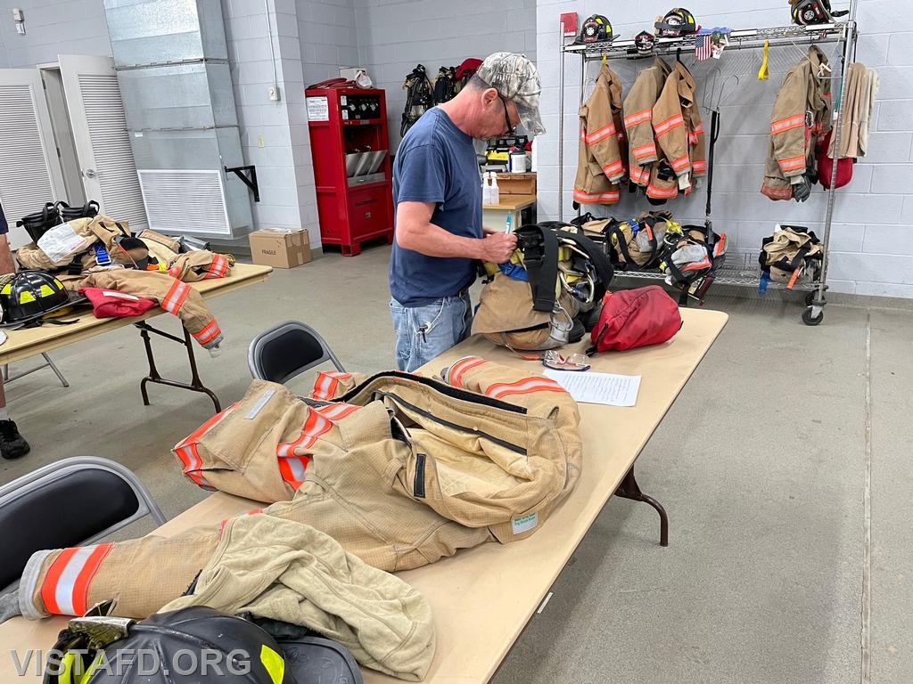 Firefighter Phil Katz conducting a gear inspection