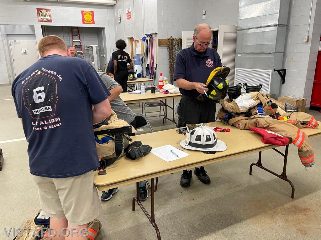 Assistant Chief Mike Peck and Ex-Chief Bill Dingee conducting a gear inspection