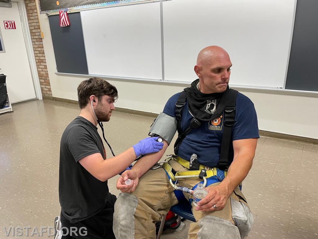 Probationary EMT Candidate Connor Mulcahy conducting rehab operations on Lt. Marc Baiocco