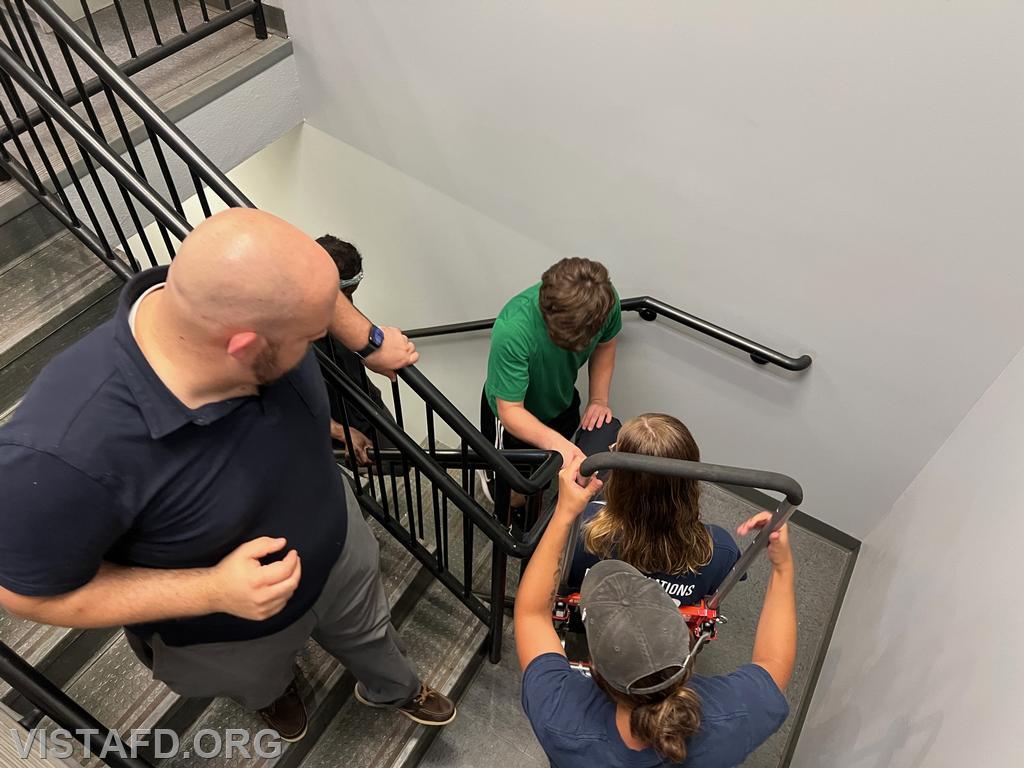 Vista EMS personnel practicing how to operate the stair chair