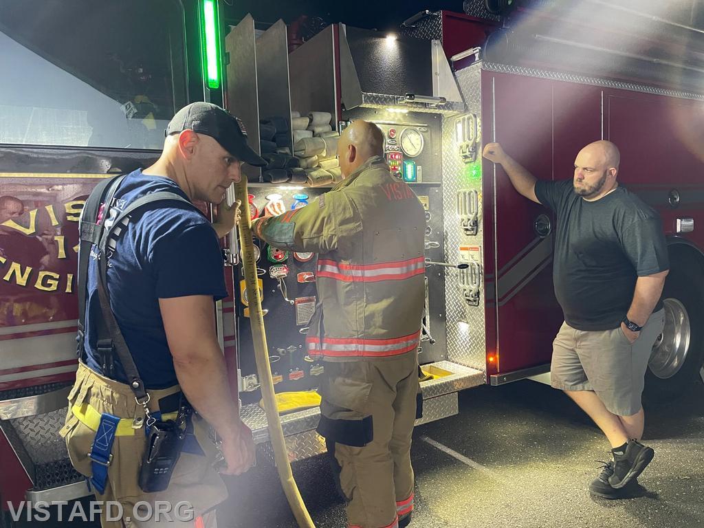 Firefighter Jose Rosa operating the Engine 141 pump panel while Lt. Marc Baiocco and FF/EMT Candidate Ryan Huntsman look on