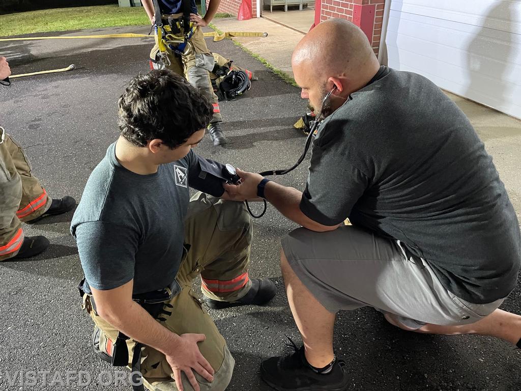 Firefighter/EMT Candidate Ryan Huntsman conducting rehab operations on Probationary Firefighter Franco Compagnone