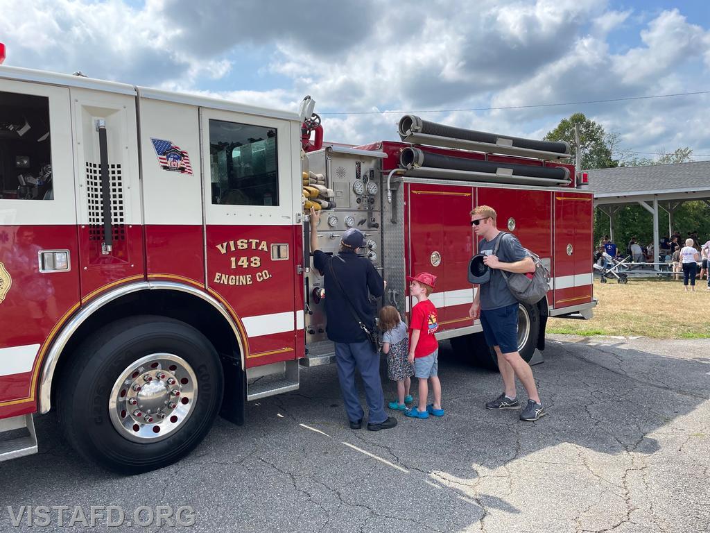 Firefighter Dom Mangone giving a tour of Engine 143 during the Kid's Community Club of Lewisboro's Ice Cream Social event