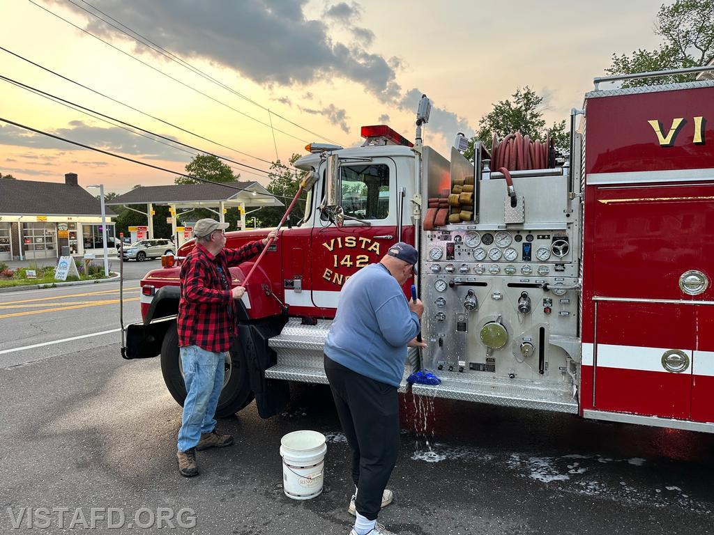 Ex-Chief Jim Hackett and Firefighter Ron Egloff cleaning Engine 142