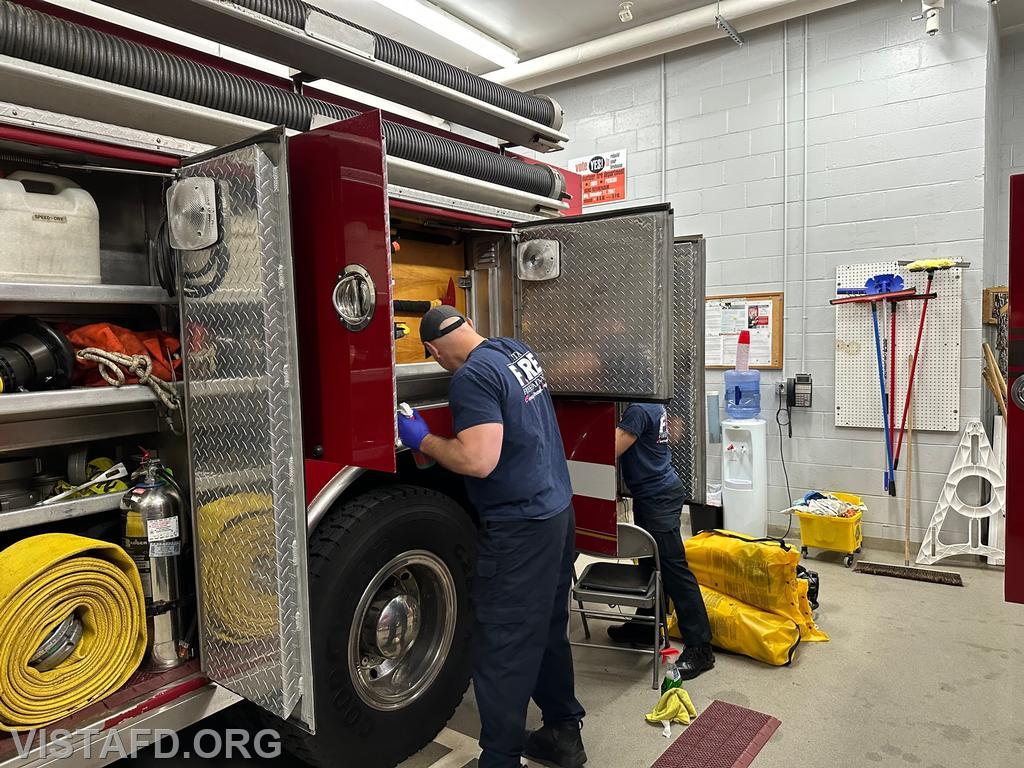 Captain Marc Baiocco and Foreman Kyla Whalen cleaning Engine 143