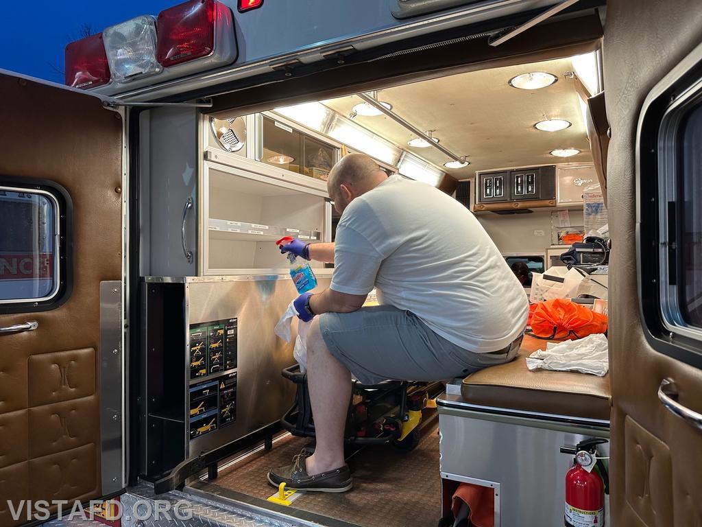 Firefighter/EMT Ryan Huntsman cleaning Ambulance 84B2