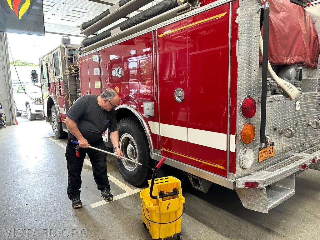 Firefighter Mark Albert cleaning Engine 143