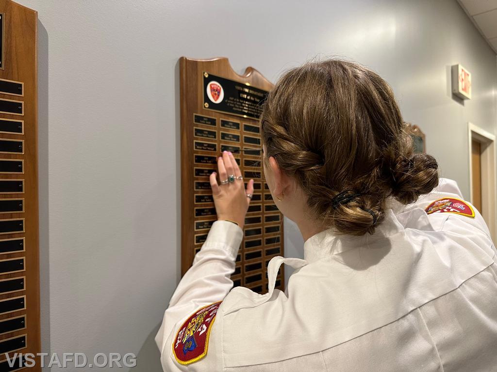 Foreman Isabel Fry putting her name on the Vista Fire Department "EMT of the Year" plaque