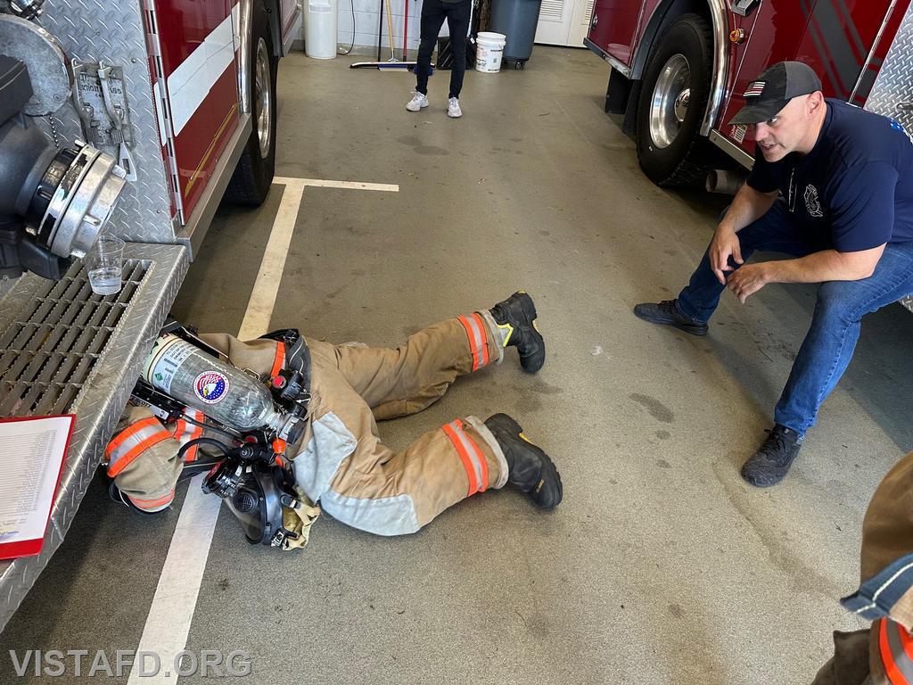 Probationary Firefighter Franco Compagnone conducting a low profile of an SCBA