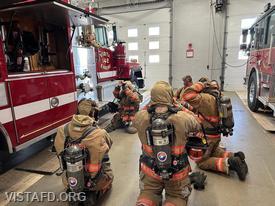 Foreman Kyla Whalen going over how to put on an SCBA during "Firefighter Skills Class"