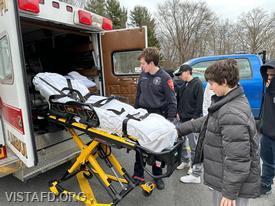 EMT Grant Vialardi going over our stretcher with John Jay High School Students