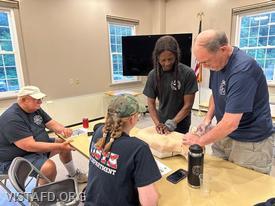 Ex-Chief Jim Hackett and Firefighter Judith Le Gall practicing CPR