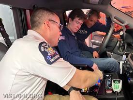 Station Manager Brian Porco going over the driving controls of the new Ambulance 84B2 with EMT Grant Vialardi and Firefighter/EMT Candidate Pietro Cipriano