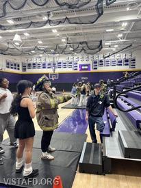 Firefighter Dom Mangone assisting John Jay High School students during a “Trial by Fire” station (Photo credit: Katonah-Lewisboro School District)