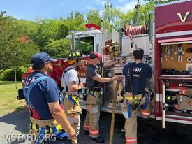 Captain Marc Baiocco reviews Engine 142 pump panel operations with Firefighter Eric Lavelanet and Firefighter/EMT Ashtin Rama as Foreman Martin Rojas looks on