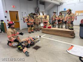Captain Marc Baiocco reviewing downed firefighter packaging using F.A.S.T. (Firefighter Assist and Search Team) techniques