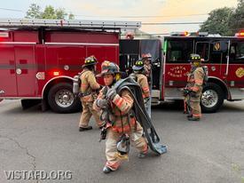 Probationary Firefighter/EMT Candidate Hanna Zhao stretching a 1¾-inch hoseline from Engine 141 during the "Initial Fire Attack Operations" drill