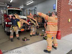 Assistant Chief Brian Porco reviewing how to properly put on firefighting gear with our EMS personnel during the "Fire and EMS Familiarization" drill