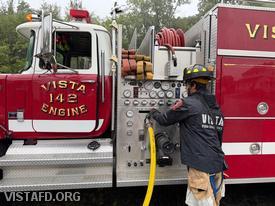 Firefighter/EMT Ashtin Rama operating the Engine 142 pump panel