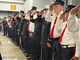 Members of the Vista Fire Department and South Salem Fire Department, along with Lewisboro Police officers, salute during the National Anthem at the 9/11 Memorial Service