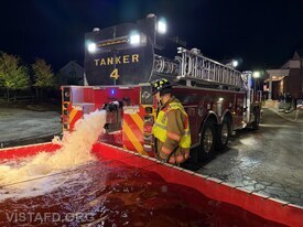 Vista Tanker 4 dumping water into the portable pond during the "New Canaan Tanker Shuttle" drill